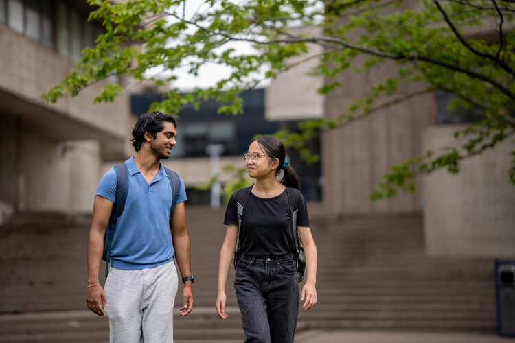two students walking on campus together