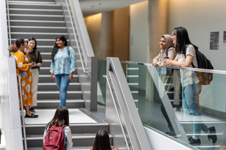 students standing by a stairway looking out